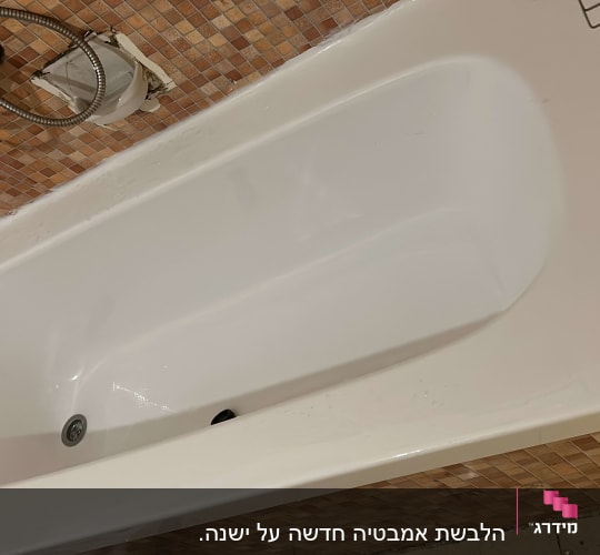 אמבטיה לבנה עם חיפוי קיר אריחים קטנים